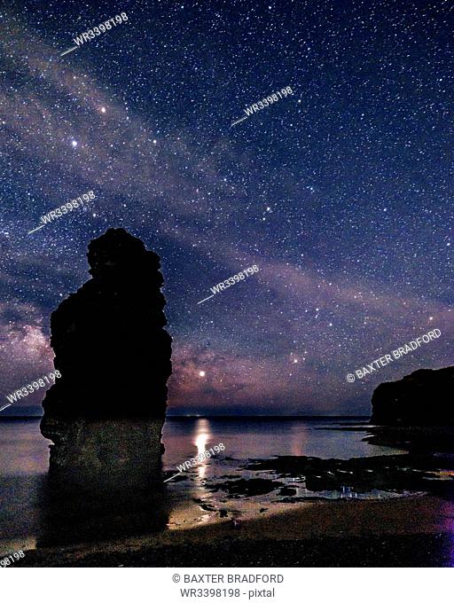 Milky Way and Jupiter beyond a majestic sea stack at Ladram Bay, Sidmouth, Devon, England, United Kingdom, Europe