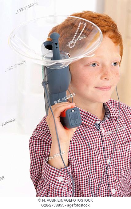 6 year old boy using a sound amplifying spy device