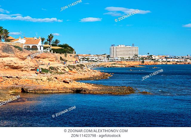 Orihuela, Spain - November 5, 2017: Rocky coastline of Cabo Roig, popular place for holidaymakers. Situated in between La Zenia to the north and Campoamor to...