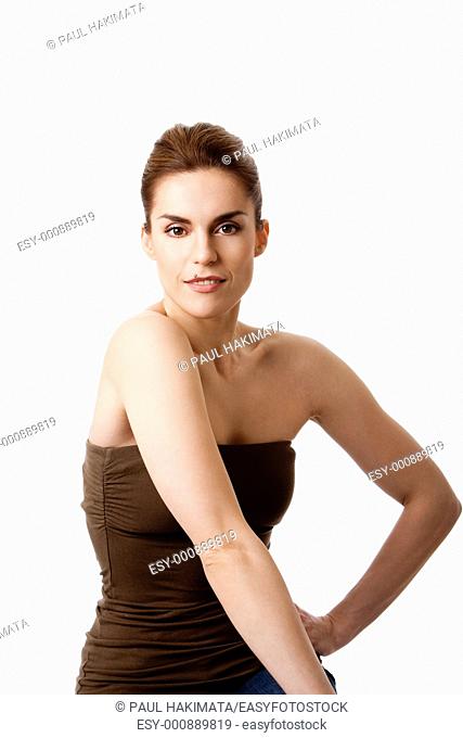 Torso of beautiful brunette with mole on lip and arm at hip, natural and pure, isolated