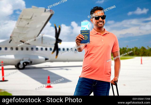 happy man with air ticket and immunity passport