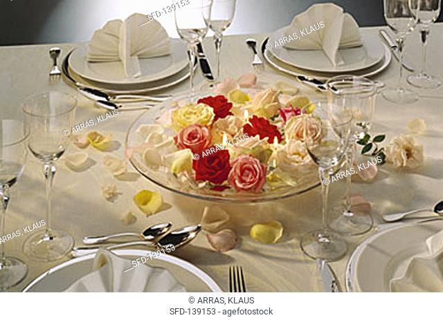 Formal Table Setting with a Centerpiece of Roses and Candles