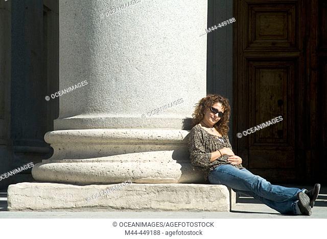 Woman by column of Prado Museum, Madrid. Spain
