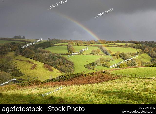 A double rainbow over an autumnal Barle Valley near Withypool in Exmoor National Park, Somerset, England