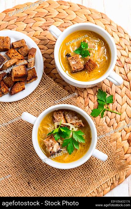 Traditional French onion soup with toasted bread croutons for autumn and winter