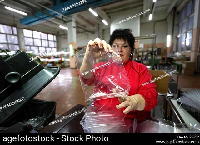 RUSSIA, VORONEZH - DECEMBER 19, 2023: An employee is at work at a Christmas ornaments packaging line at the Igrushki toy factory
