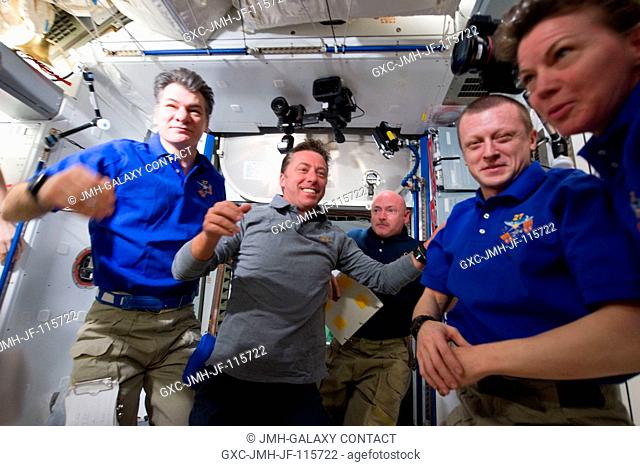 STS-134 and Expedition 27 crew members are pictured in the Harmony node of the International Space Station shortly after space shuttle Endeavour and the space...