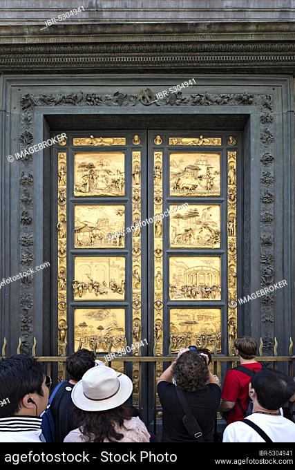 FLORENCE, AUGUST 16: Tourists in front of the Golden Door of the Baptistery of Florence (Battistero di San Giovanni) on August 16, 2012 in Italy