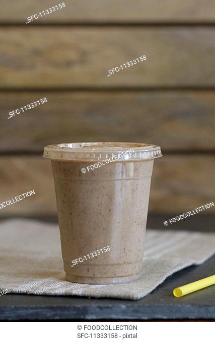 A smoothie made with almond milk, dates, bananas, cocoa, almond butter and cinnamon