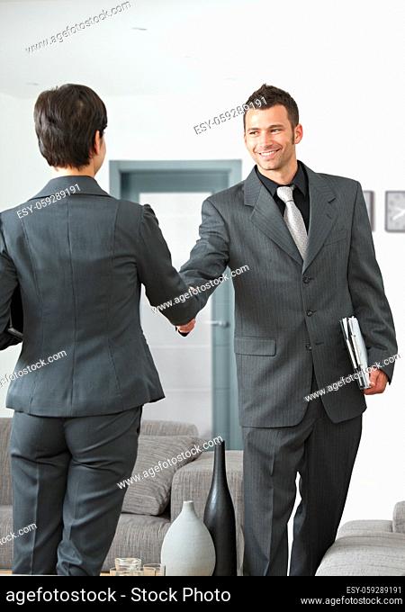 Business meeting at office lobby partners shaking hands