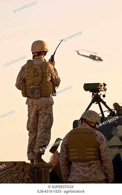 U.S. Marine Forward Air Controllers and a Marine UH-1N Attack Helicopter