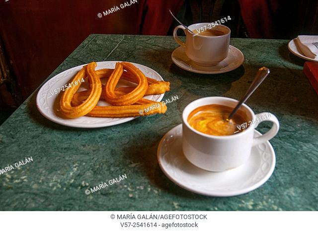 Two cups of coffee with churros in a cafe. Madrid, Spain