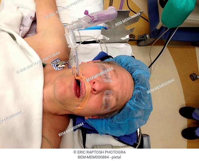 Caucasian woman under anesthetic in surgery