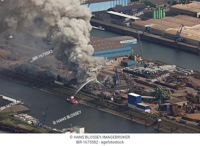 Aerial view, smoke, fire on a scrap island in the Duisport inland port, Duisburg, Ruhrgebiet region, North Rhine-Westphalia, Germany, Europe