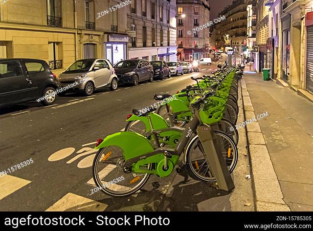 Paris, France - December 21, 2018: The terminal of the Velib bike rental system on an evening Parisian street, France