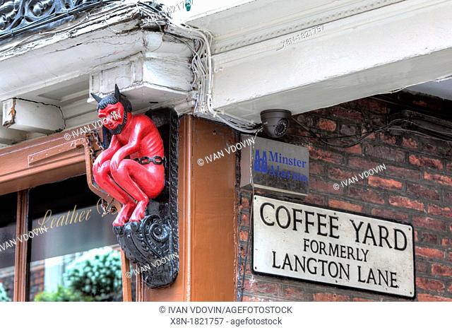 Sculpture of devil on facade of old house, printer's shop at 33 Stonegate street, York, North Yorkshire, England, UK