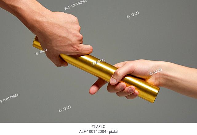 Hands holding baton
