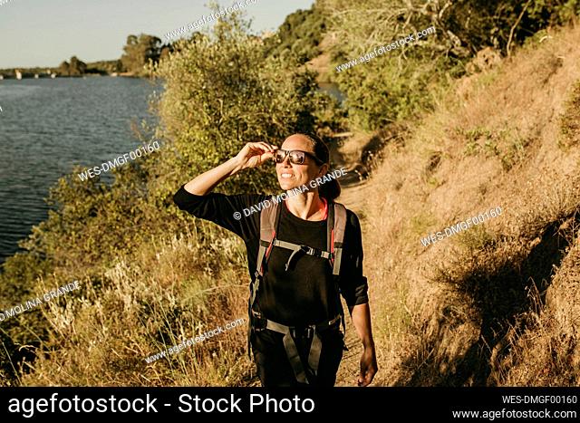 Smiling woman trekking on footpath at Sierra De Hornachuelos, Cordoba, Spain
