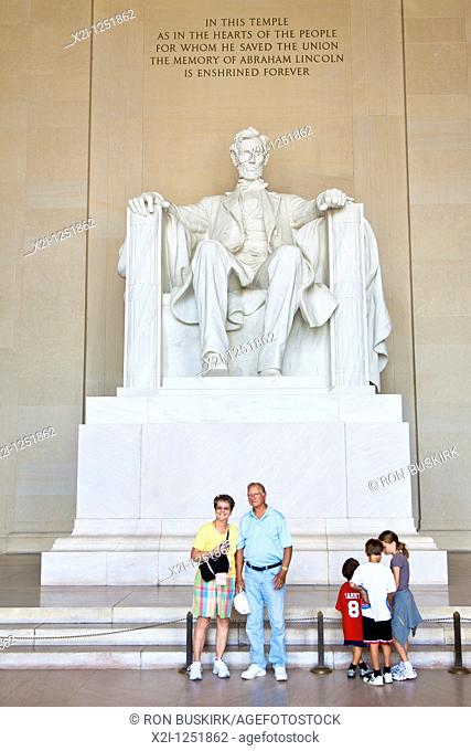 Washington DC - Tourists pose for pictures in front of the sculpture at the Lincoln Memorial in Washington DC