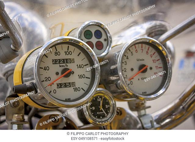 Speedometer of a vintage motorcycle, with worn chrome by time and travel made