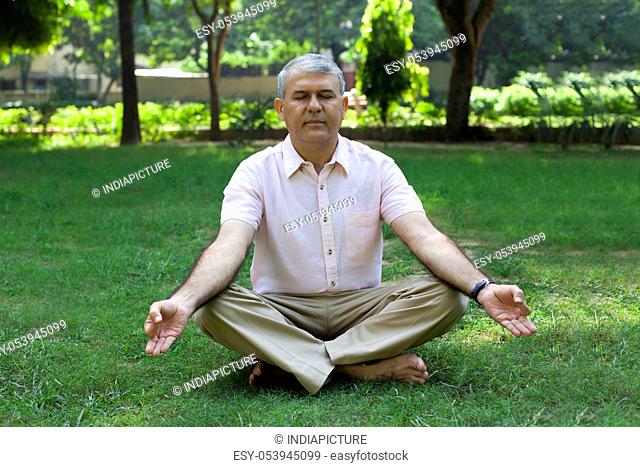 Senior man meditating in park