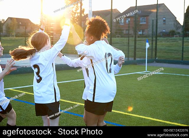 UK, Female soccer players cheering in field