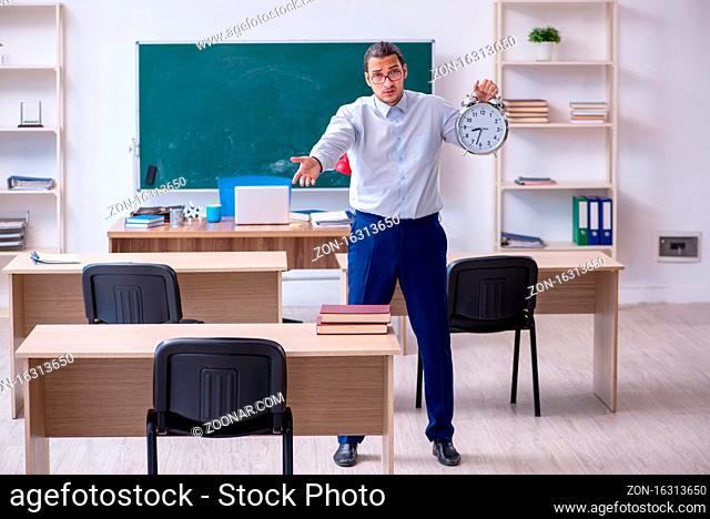 Young teacher in front of green board