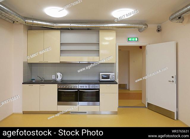 Modern youth hostel building. Kitchen with two ovens, kettle and toaster
