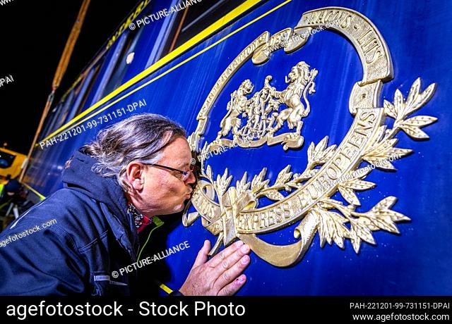 30 November 2022, Mecklenburg-Western Pomerania, Gadebusch: Holger Hempel, the proud new owner, kisses the Orientexpress coat of arms after transferring the...