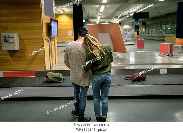 Couple embracing each other at airport