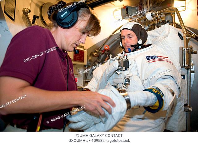 Astronaut Robert S. (Shane) Kimbrough, STS-126 mission specialist, participates in an Extravehicular Mobility Unit (EMU) spacesuit fit check in the Space...