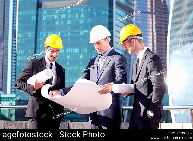Engineering and architecture concept, engineers working on a building site holding blueprints , architects and engineers inspection in workplace for...