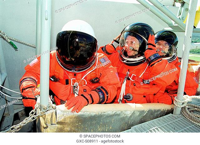 11/09/2001 -- The Expedition 4 crew sit in the slidewire basket, part of the emergency egress system from the 195-foot level of the Fixed Service Structure on...