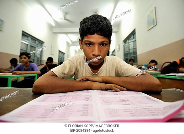Student poring over a textbook, school teaching in a middle school, Youhanabad, Lahore, Punjab, Pakistan, Asia