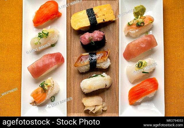 Sushi platter, a selection of raw fish and rice snacks with chopsticks