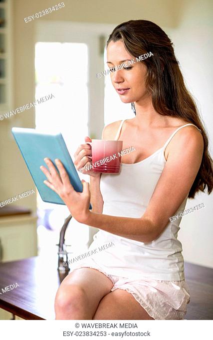Happy young woman using digital tablet