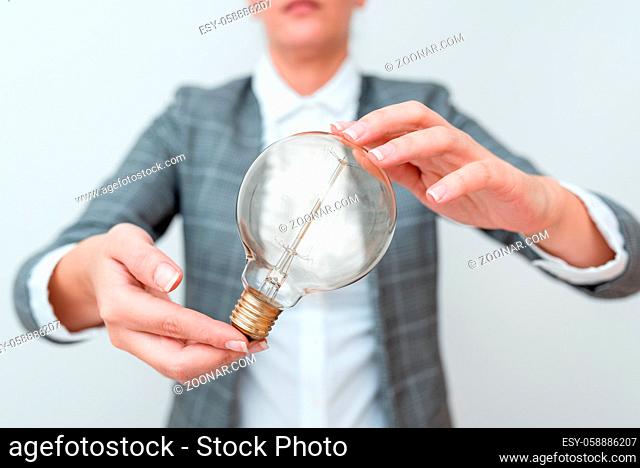 Lady Holding Lamp With Formal Outfit Presenting New Ideas For Project, Business Woman Showing Bulb With Two Hands Exhibiting New Technologies