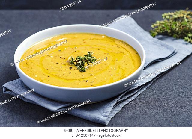 Cream of pumpkin sauce with thyme, olive oil and coarsely ground pepper