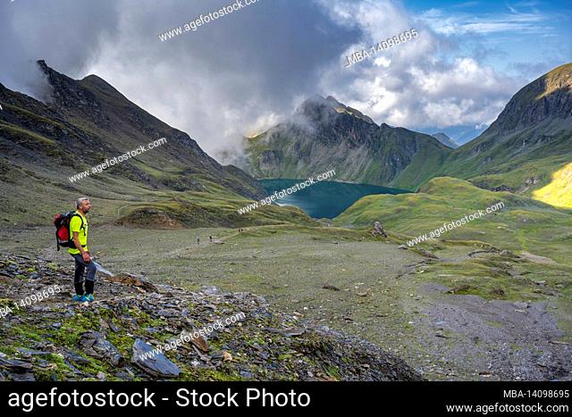 vals, mühlbach, bolzano province, south tyrol, italy. mountain hikers above the wild see