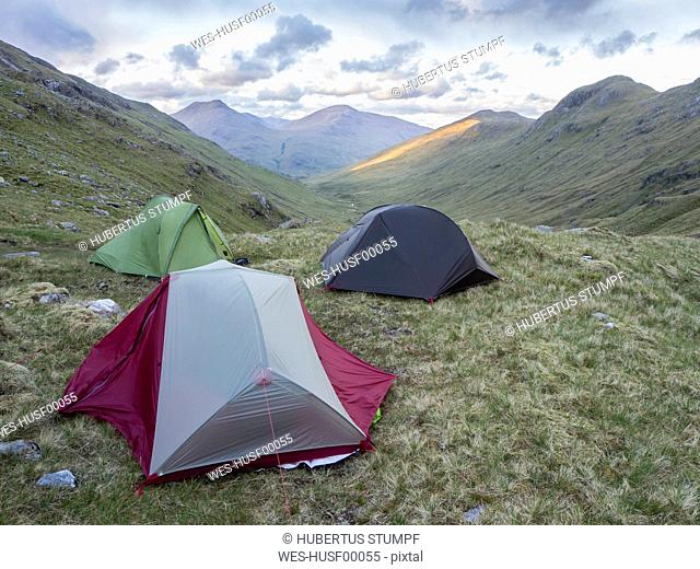 Tents on mountains against sky, Scotland, UK