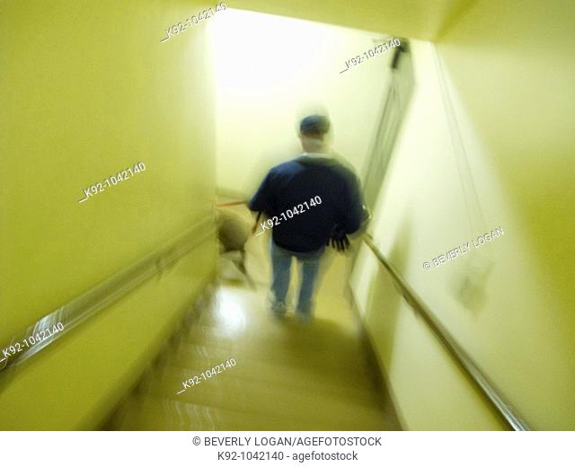 Man walking downstairs with a dog