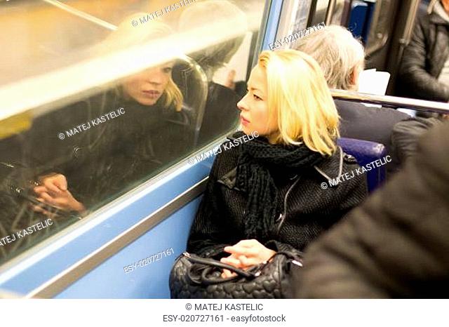Woman looking out metro's window