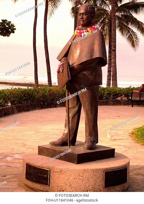Waikiki, Honolulu, Oahu, HI, Hawaii, Kuhio Beach Park, Prince Kuhio Statue with leis around his neck, dressed in business suit