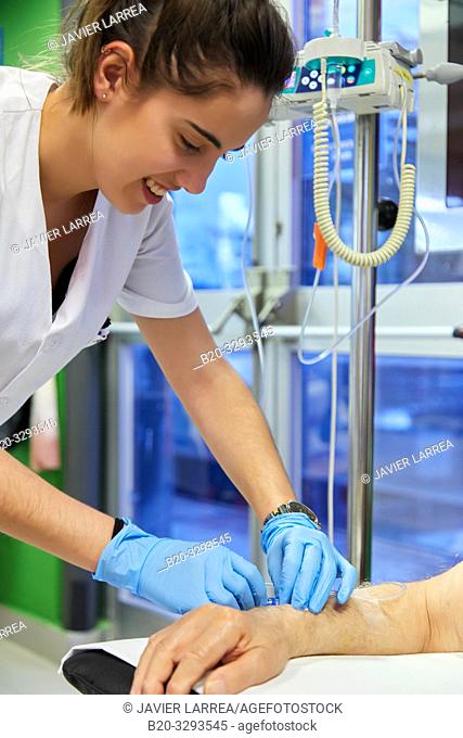 Nurse putting medication intravenously to a patient, Chemotherapy, Oncology, Hospital Donostia, San Sebastian, Gipuzkoa, Basque Country, Spain