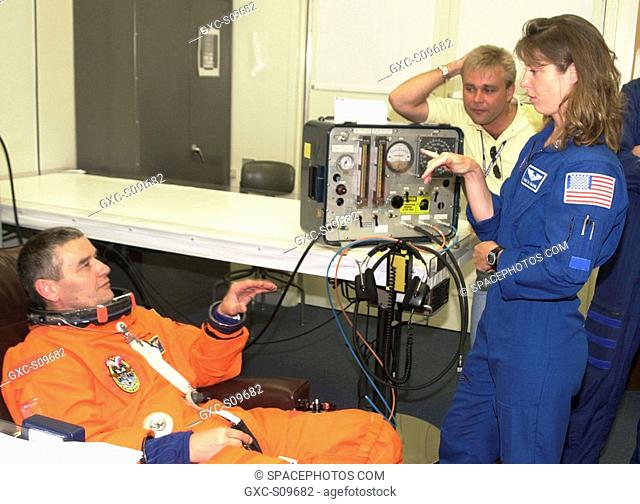 05/30/2002 -- Expedition 5 Commander Valeri Korzun RSA, left, talks with astronaut Tracy Caldwell during suitup for the scheduled liftoff of Space Shuttle...