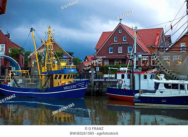 evening mood over fishing trawlers in the harbour, Germany, Lower Saxony, Neuharlingersiel