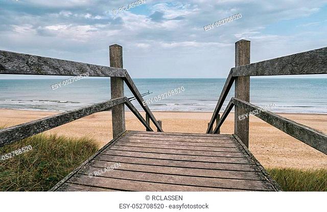 View to the Baltic sea from a Wooden path to the ocean at a cloudy day. ideal for websites and magazines layouts