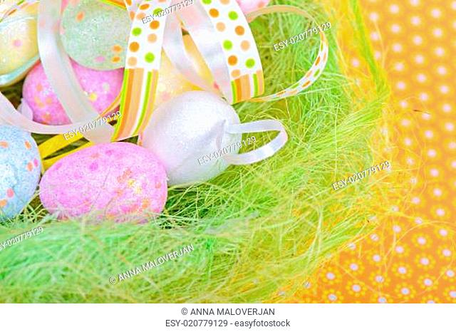 Easter eggs and ribbon in nest