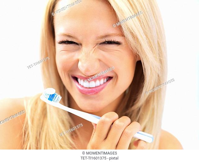 Woman about to brush her teeth