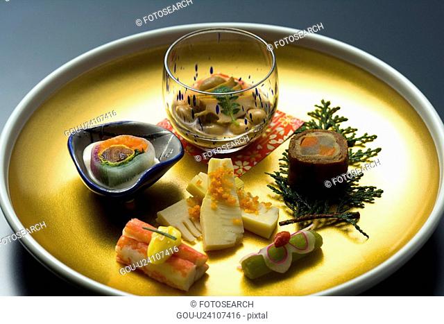 Various Japanese food on a plate, high angle view, black background, Japan